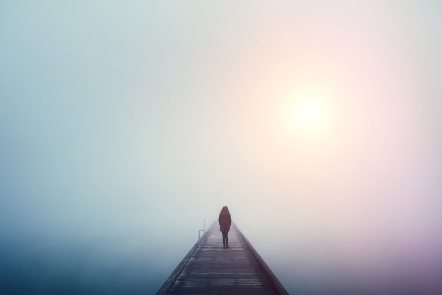 Person walking along a pier